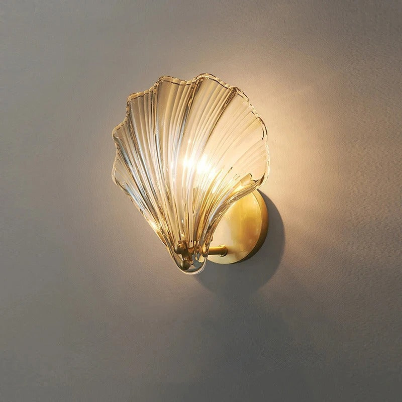 "Elegant shell-shaped wall sconce with warm LED glow, crafted from glass, enhances decor with seaside charm for home lighting