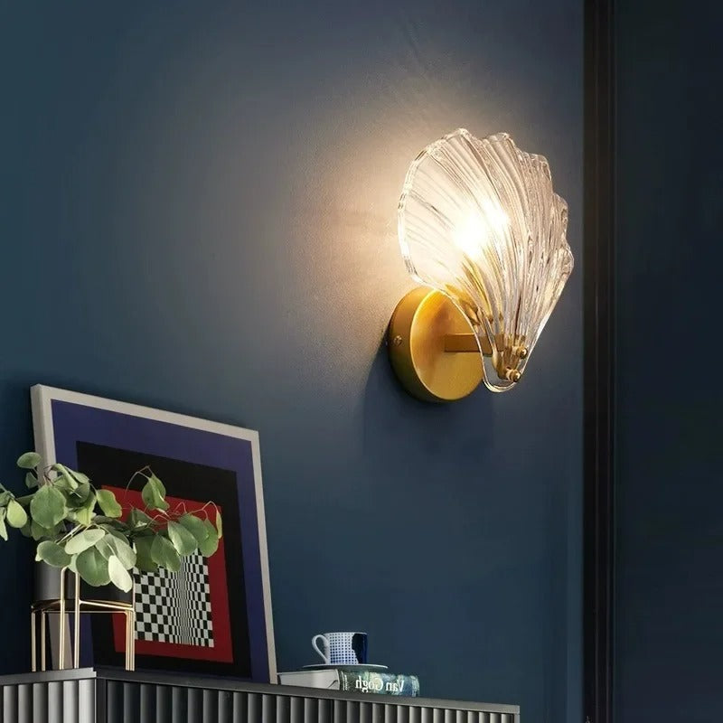 "Elegant shell-shaped wall sconce with warm LED glow, crafted from glass, enhances decor with seaside charm for home lighting