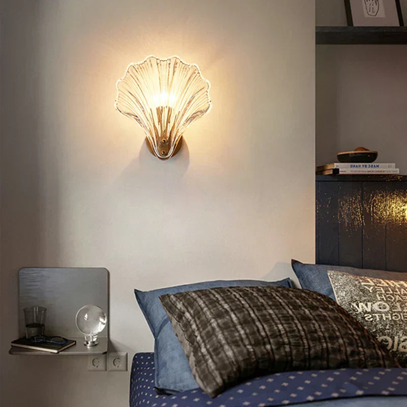 "Elegant shell-shaped wall sconce with warm LED glow, crafted from glass, enhances decor with seaside charm for home lighting