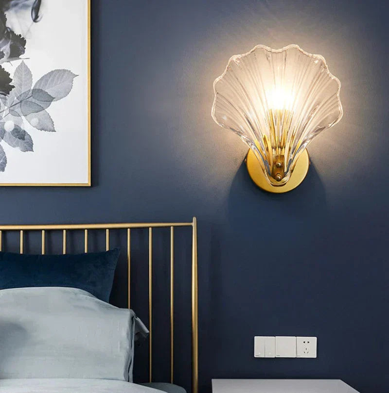 "Elegant shell-shaped wall sconce with warm LED glow, crafted from glass, enhances decor with seaside charm for home lighting
