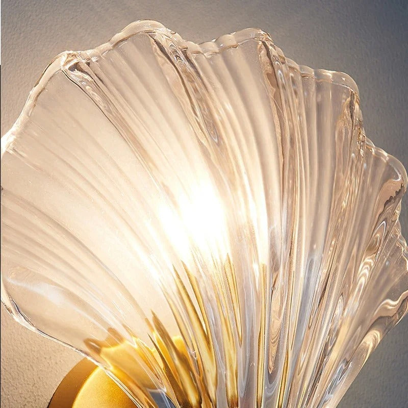 "Elegant shell-shaped wall sconce with warm LED glow, crafted from glass, enhances decor with seaside charm for home lighting
