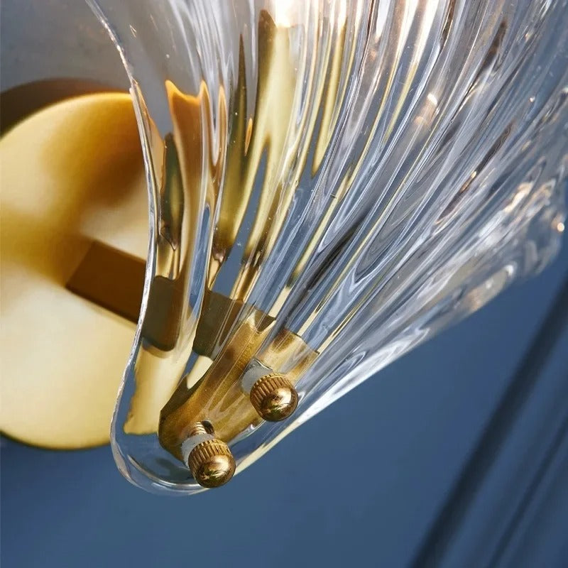"Elegant shell-shaped wall sconce with warm LED glow, crafted from glass, enhances decor with seaside charm for home lighting