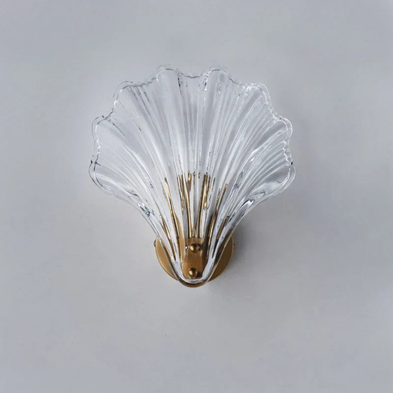 "Elegant shell-shaped wall sconce with warm LED glow, crafted from glass, enhances decor with seaside charm for home lighting