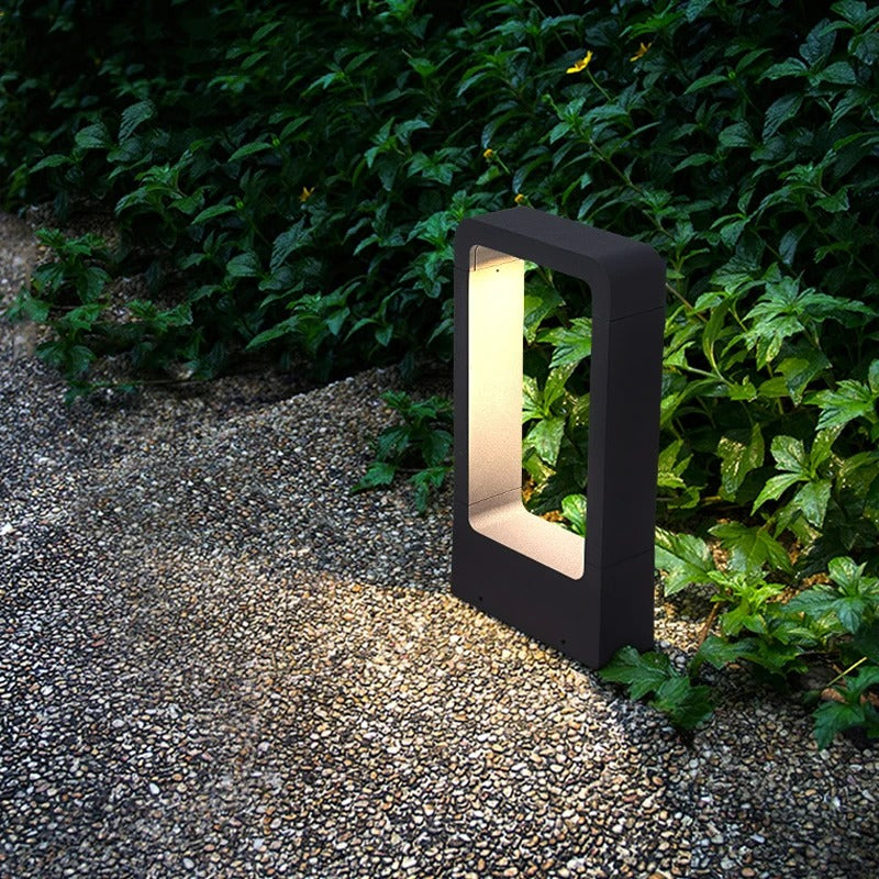 "Sleek waterproof outdoor LED garden light illuminating garden paths, robust aluminum build with modern minimalist design."