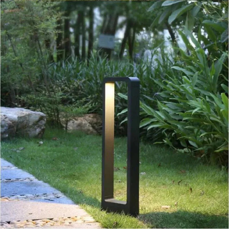 "Sleek waterproof outdoor LED garden light illuminating garden paths, robust aluminum build with modern minimalist design."
