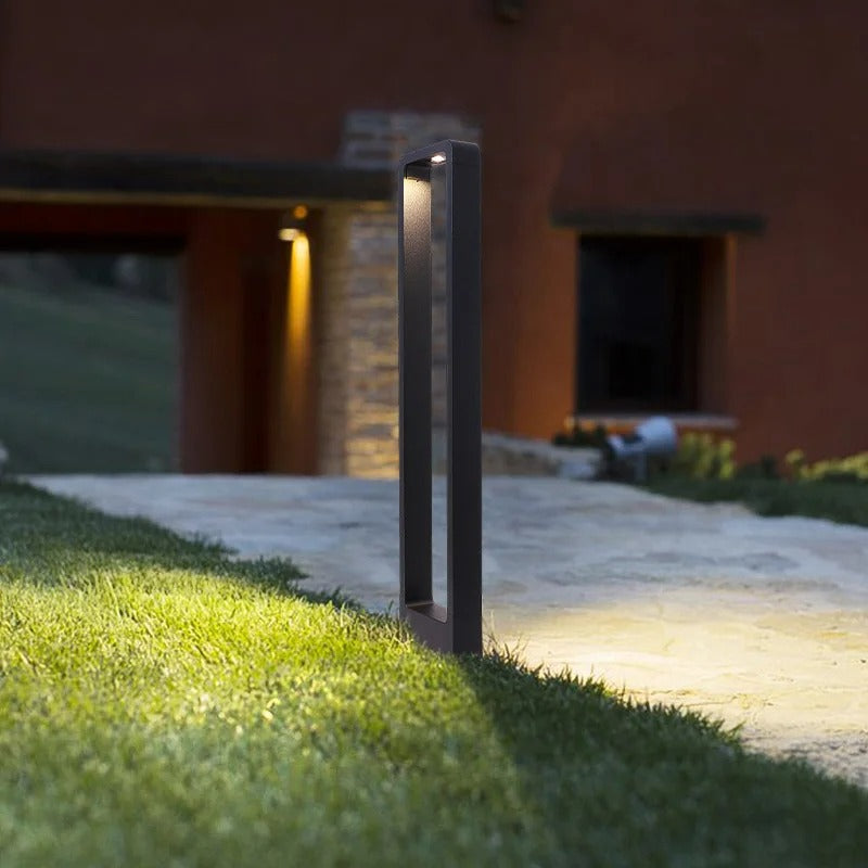 "Sleek waterproof outdoor LED garden light illuminating garden paths, robust aluminum build with modern minimalist design."