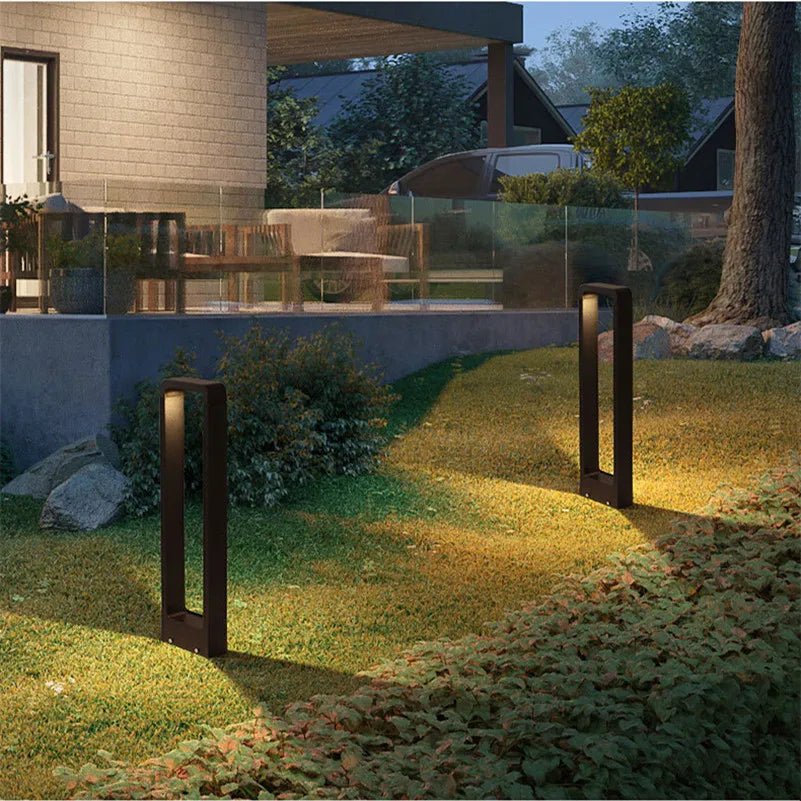 "Sleek waterproof outdoor LED garden light illuminating garden paths, robust aluminum build with modern minimalist design."