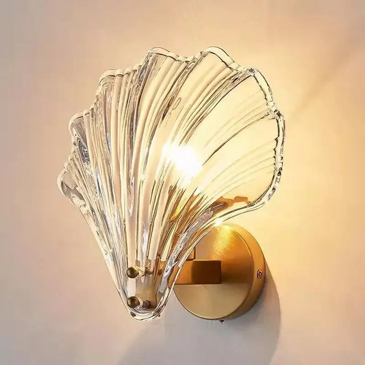 "Elegant shell-shaped wall sconce with warm LED glow, crafted from glass, enhances decor with seaside charm for home lighting