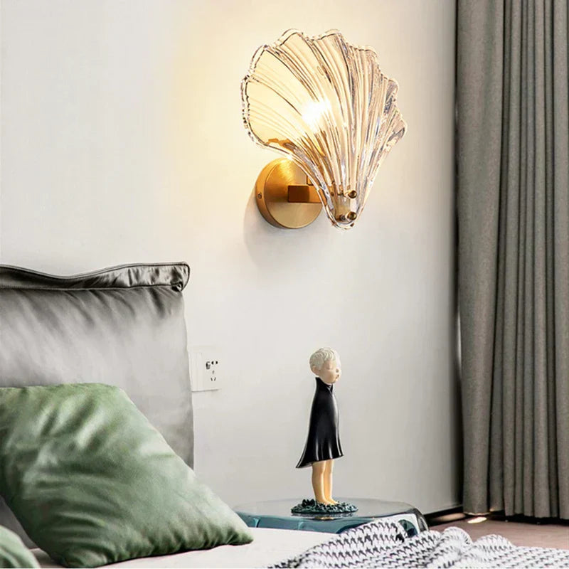"Elegant shell-shaped wall sconce with warm LED glow, crafted from glass, enhances decor with seaside charm for home lighting