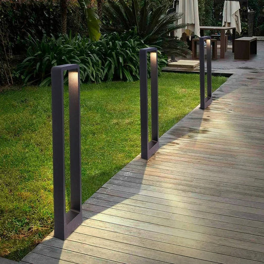 "Sleek waterproof outdoor LED garden light illuminating garden paths, robust aluminum build with modern minimalist design."